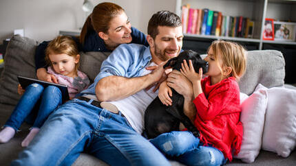 Familia jugando con un cachorro negro