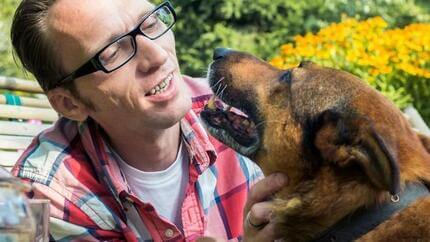 Man outside talking to dog