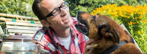 Man outside talking to dog